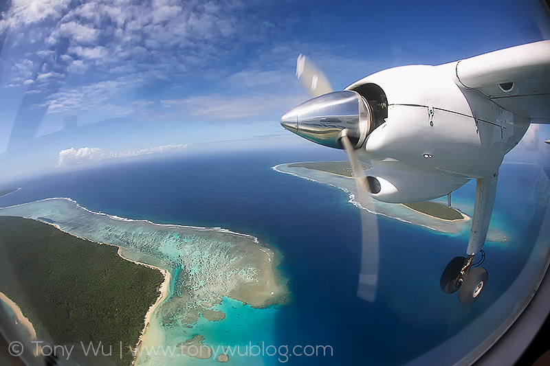 flying over islands and blue water in kingdom of tonga