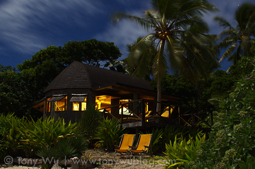 One of the bungalows at Mounu Island Resort, under a full moon
